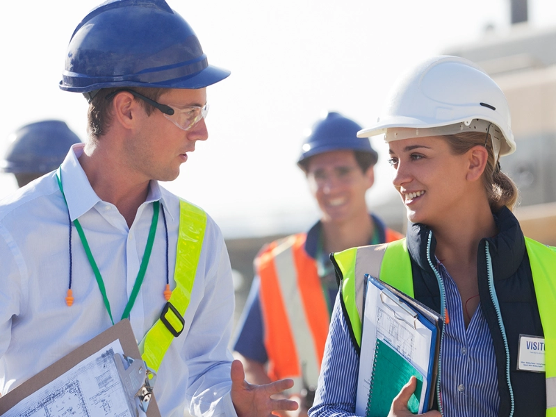 Construction workers talking at a work site